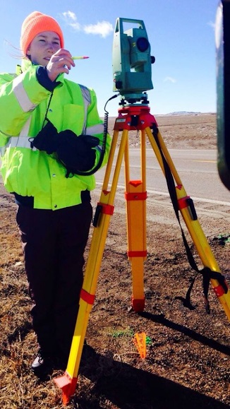 Sydney James using surveying equipment